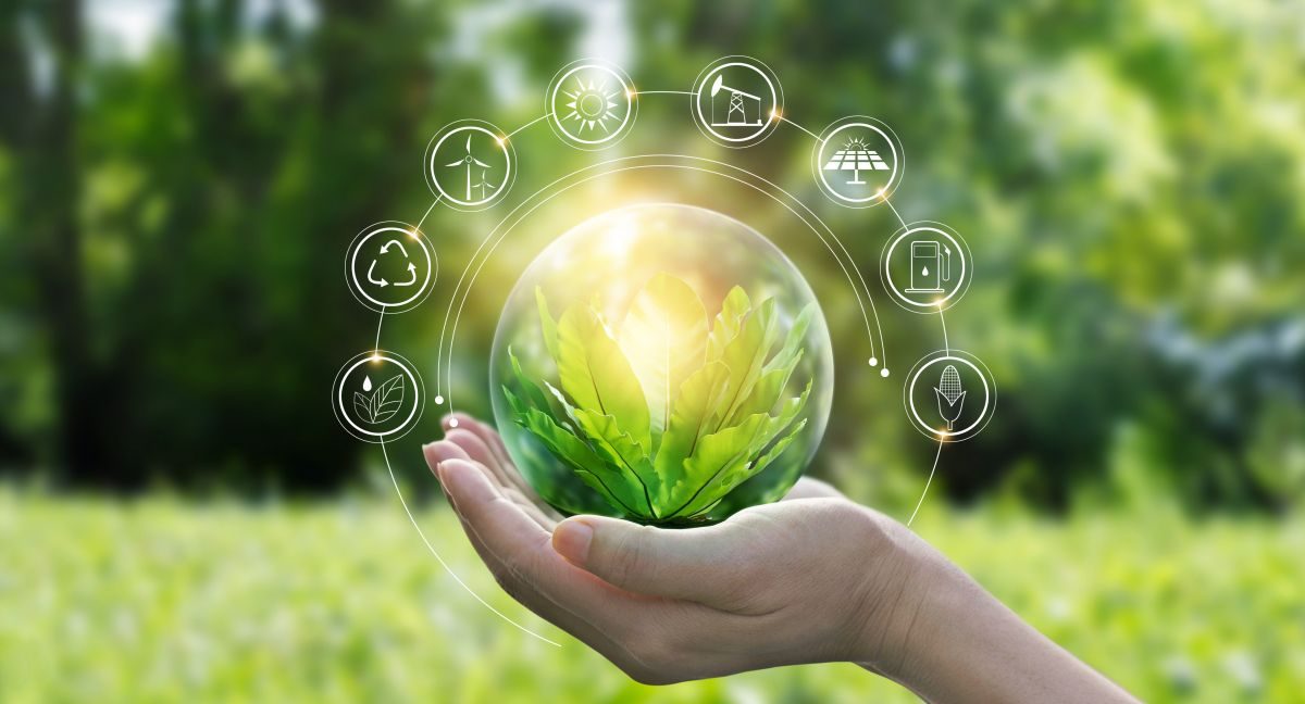 Hand holding a glass sphere with a plant, surrounded by technology icons