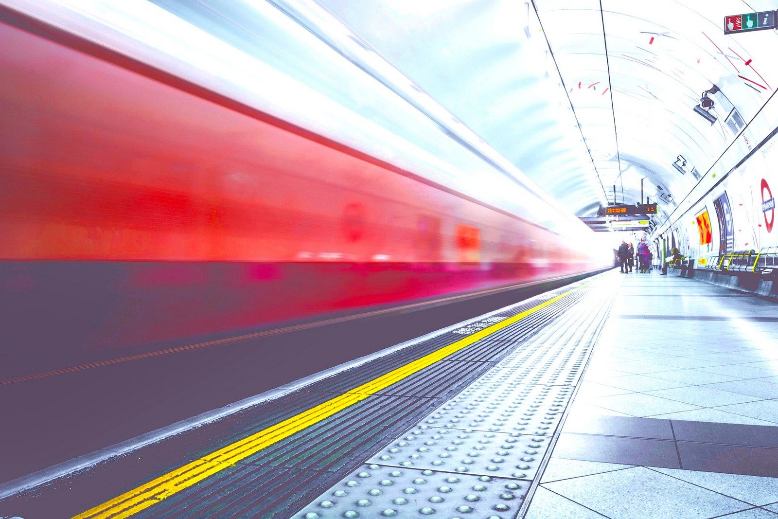 Train passing through a station at speed