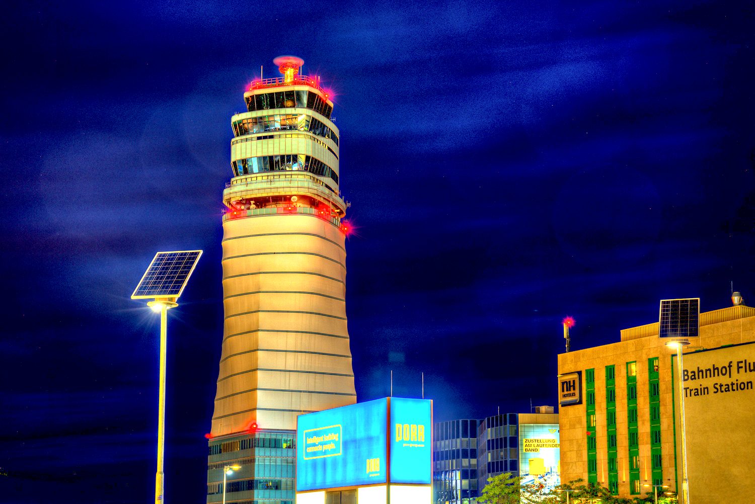 Solar street light in front of an airport tower at night