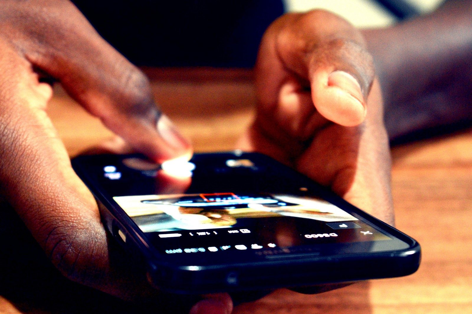 Hands using a mobile phone